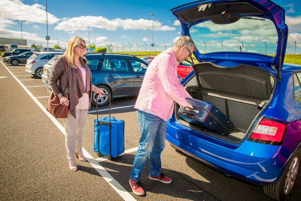 Couple loading luggage into a car