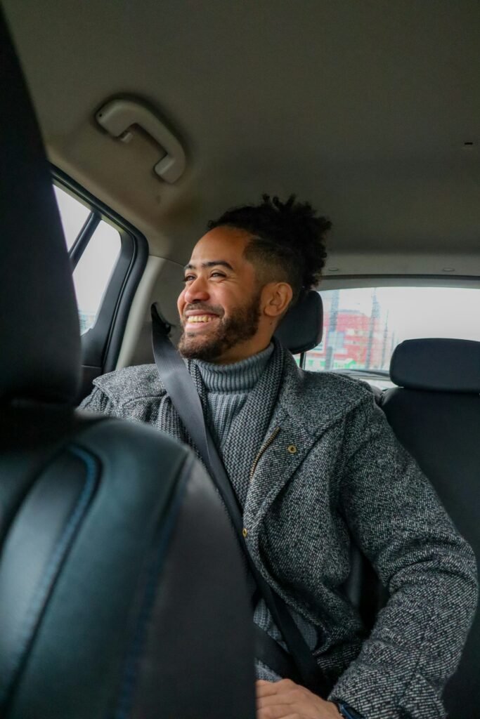 Smiling passenger in the back seat of a car